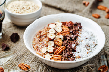 Chocolate Quinoa breakfast bowl decorated with hazelnuts, Pecan,