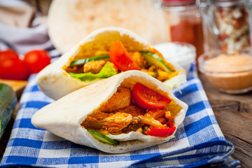 Fried chicken meat with vegetables in pita bread