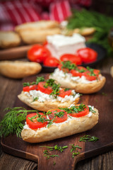 Delicious bruschetta with tomatoes, feta cheese, dill and spice