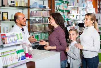 pharmacist  helping customers