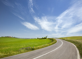 road under sky clouds in Tuscany in Italy