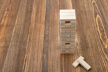 The tower of wooden blocks placed on a table.