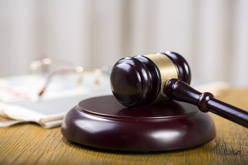 Obraz premium Labor law concept, gavel, glasses and newspaper on wooden table