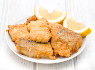 pieces of fried hake dish with lemon