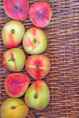 Fresh donut saturn peaches on rustic wicker background