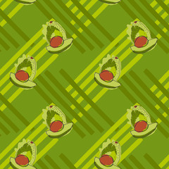 Green avocado with brown kernel on stripes