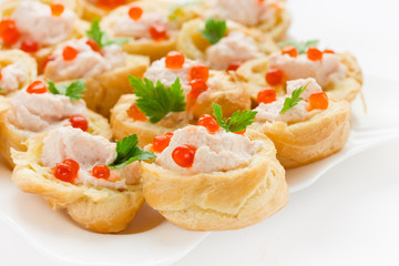 Tartlets of choux dough with salmon mousse and red caviar
