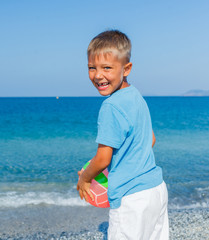 Fototapeta na wymiar Boy playing ball at the beach