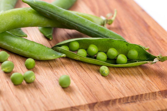fresh green peas on a wooden background