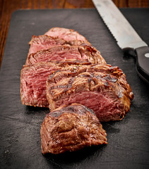 grilled sliced beef steak and knife