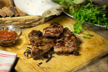 Grilled meat on a laid table