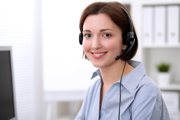  Young beautiful business woman in headset. Call center.