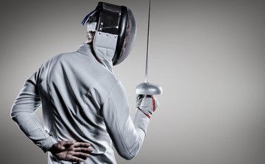 Composite image of man wearing fencing suit practicing with sword - obrazy, fototapety, plakaty