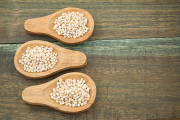 Millo grains on wooden background