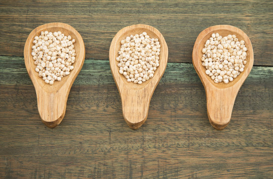 Millo grains on wooden background