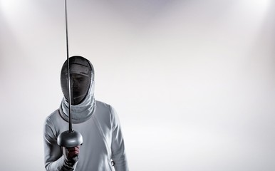 Composite image of man wearing fencing suit practicing with sword