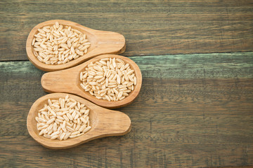 Oat grains on wooden background