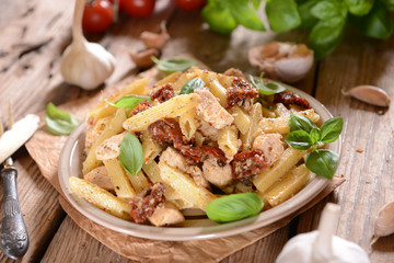 Penne pasta with chicken, dried tomatoes and ruckola