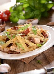 Penne pasta with chicken, dried tomatoes and ruckola