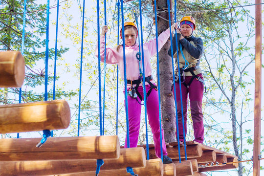 girl climbs into ropes course