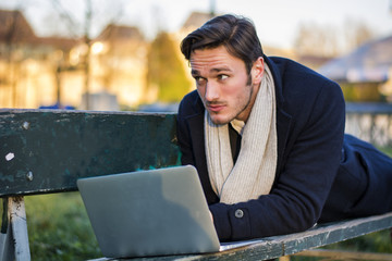 Handsome elegant businessman working in a park