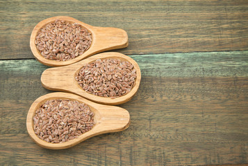 Flax seeds on wooden background