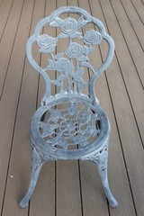 Ornamental steel chair on decking