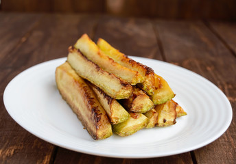 Baked zucchini squash in the form of sticks. Vegan diet kitchen.