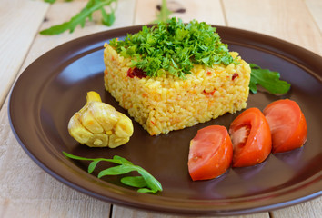 Central Asian traditional dish - pilaf (plov risotto) in the form of a square, decorated with chopped parsley in clay bowl on a light wooden background.