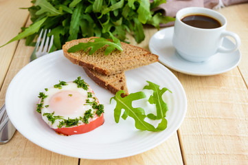 Scrambled eggs, baked in a ring bell pepper, toast, arugula leaves and a cup of coffee. Light breakfast.