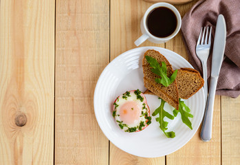 Scrambled eggs, baked in a ring bell pepper, toast, arugula leaves and a cup of coffee. Light breakfast.