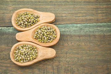 Mung beans on wooden background