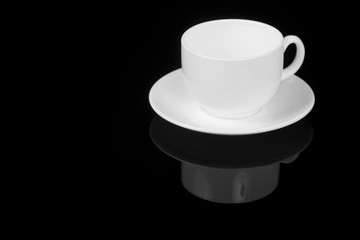 White cup on glossy black background