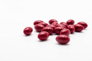 vitamin red pills selective focus on white background