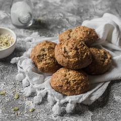 Multi seeds whole wheat buns on a grey stone background. Healthy food