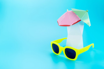 yellow sunglasses with polygon vase and beach umbrella,Vacation