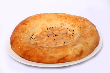Tasty bread cake on the plate on white background