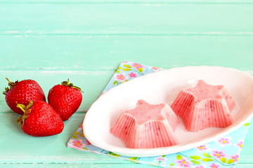 Fresh and flavorful strawberry ice cream on a plate. Frozen sweet strawberry yogurt shaped star....