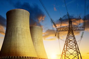 Nuclear power plant with high voltage tower at sunset - 113661026