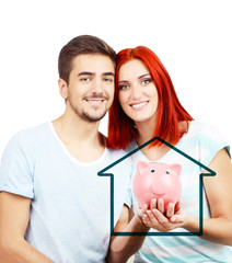 Loving couple sitting in sofa with piggy bank in room