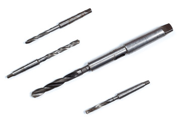Four twist drill taper shank. White background.