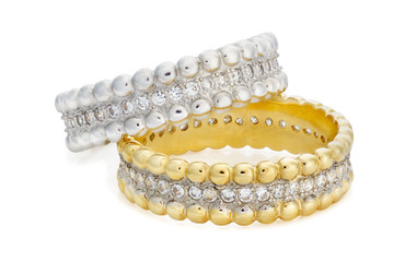 Close-up on two bracelets made of a gold and a silver with diamo