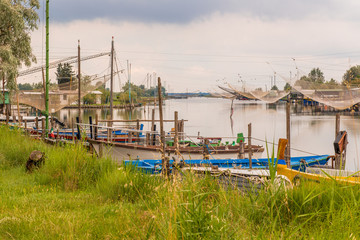 ships and fishing huts in the quiet of brackish lagoon