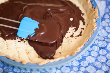Pouring chocolate on a tart