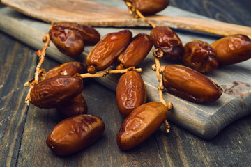 branch of date fruits on wood