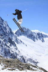 Ski rider jumping on mountains. Extreme ski freeride sport.