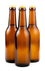 Bottle of beer with drops isolated on white background