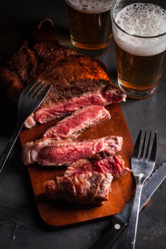 Close-up of a raw steak with beer