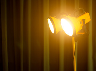 Halogen work lights on yellow tripod,dark background