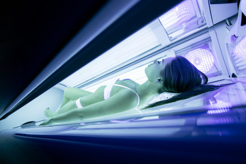 Beautiful woman lying in solarium